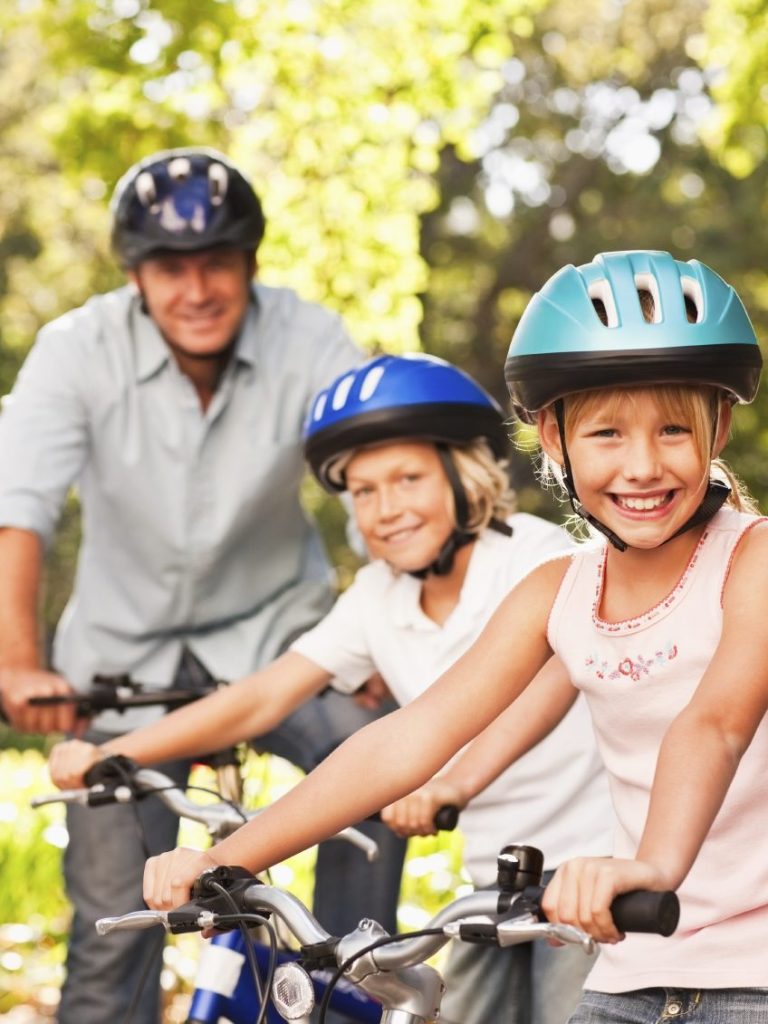 Family cycling with helmets